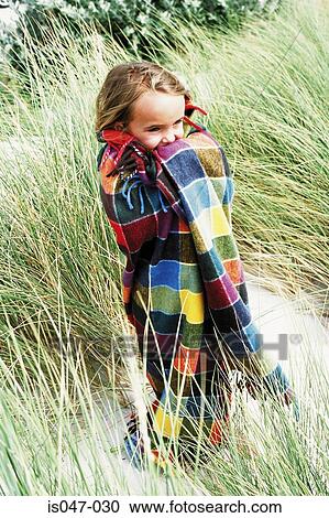 Girl wrapped up in a checked blanket View Large Photo Image Stock Image - Girl wrapped up in a checked blanket. Fotosearch