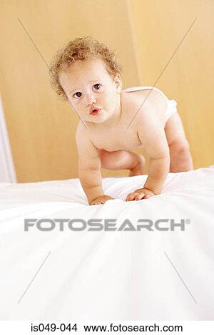 Picture - Baby in bed. Fotosearch
