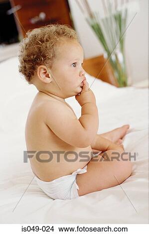 Baby on bed View Large Photo Image Picture - Baby on bed. Fotosearch