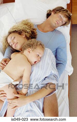 Stock Image - Family in bed. Fotosearch