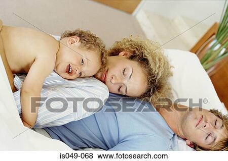 Family in bed View Large Photo Image Stock Photo - Family in bed. Fotosearch