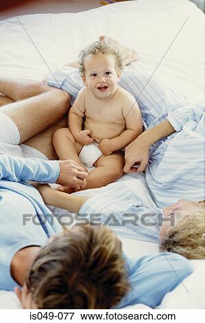 Stock Photo - Family in bed. Fotosearch