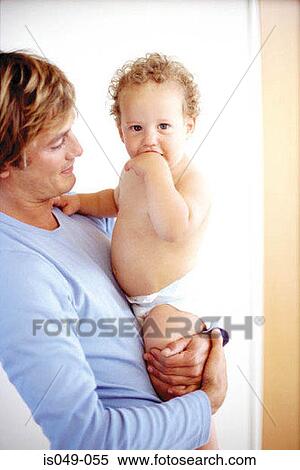 Stock Photography - Father holding baby. Fotosearch