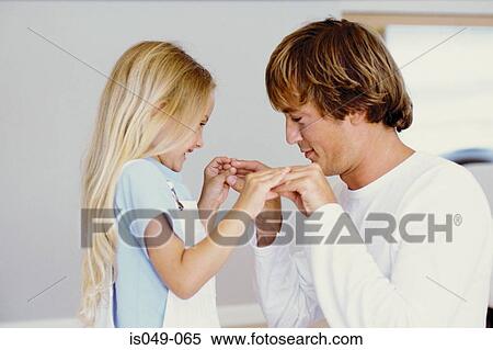Stock Photography - Girl playing with her father. Fotosearch