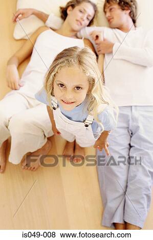 Girl with her mother and father View Large Photo Image Stock Photo - Girl with her mother and father. Fotosearch