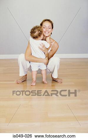 Mother hugging baby View Large Photo Image Stock Photograph - Mother hugging baby. Fotosearch