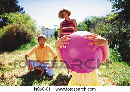 Girl holding ball with parents View Large Photo Image Stock Image - Girl holding ball with parents. Fotosearch