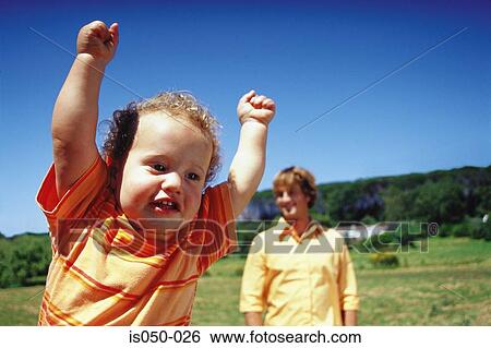 Happy baby with arms up in the air View Large Photo Image Stock Photograph - Happy baby with arms up in the air . Fotosearch