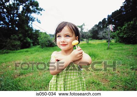Little girl having a lollipop View Large Photo Image Picture - Little girl having a lollipop. Fotosearch