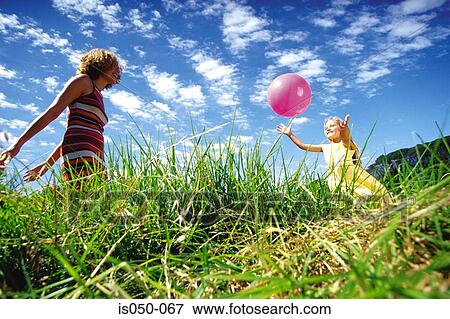 Mother and daughter playing with ball View Large Photo Image Stock Photo - Mother and daughter playing with ball. Fotosearch
