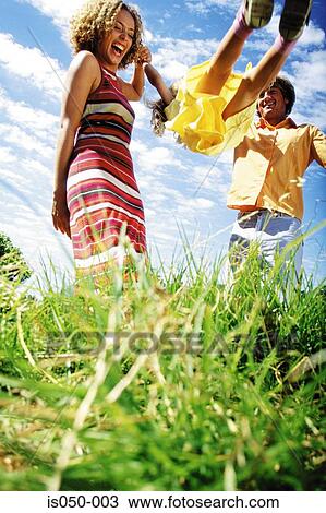 Parents playing with daughter in a park View Large Photo Image Stock Image - Parents playing with daughter in a park. Fotosearch