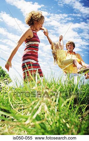 Stock Photography - Parents playing with daughter. Fotosearch