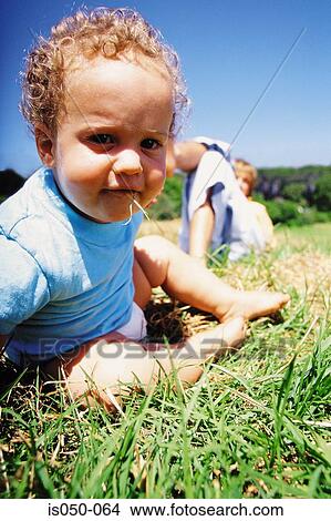Toddler eating grass View Large Photo Image Picture - Toddler eating grass. Fotosearch