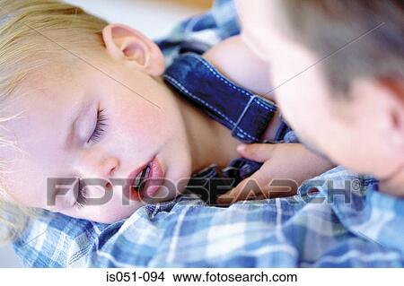 Baby sleeping in dad's arms View Large Photo Image Picture - Baby sleeping in dad's arms. Fotosearch