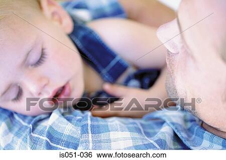 Baby sleeping in fathers arms View Large Photo Image Stock Photograph - Baby sleeping in fathers arms. Fotosearch