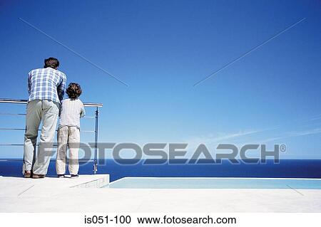 Dad and son on the balcony View Large Photo Image Stock Image - Dad and son on the balcony. Fotosearch