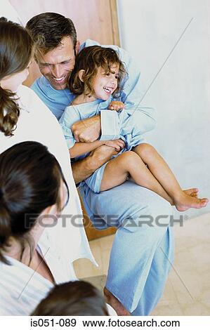 Stock Photo - Family having fun at home. Fotosearch
