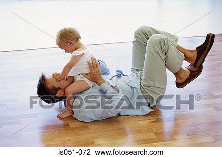 Stock Image - Father playing with toddler. Fotosearch
