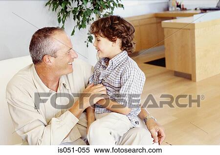 Grandad with grandson on his lap View Large Photo Image Stock Photography - Grandad with grandson on his lap. Fotosearch