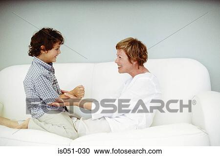 Grandmother playing with grandson on the sofa View Large Photo Image Stock Image - Grandmother playing with grandson on the sofa. Fotosearch