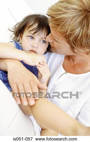 Stock Photo - Grandmother with granddaughter on her lap. Fotosearch