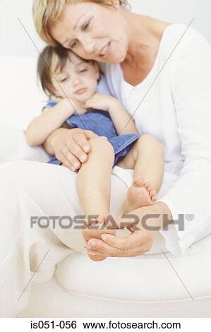 Stock Photograph - Grandmother with granddaughter on her lap. Fotosearch