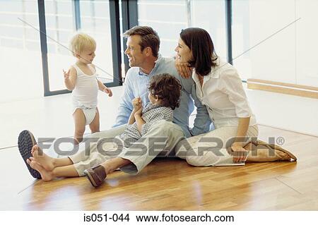Happy family at home View Large Photo Image Stock Photo - Happy family at home. Fotosearch - Search Stock Images, Mural Photographs, Pictures, and Clipart Photos