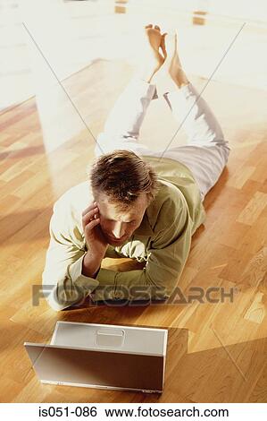 Stock Photograph - Young businessman working from home. Fotosearch