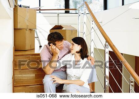 Young couple unpacking in their new house View Large Photo Image Stock Photo - Young couple unpacking in their new house. Fotosearch