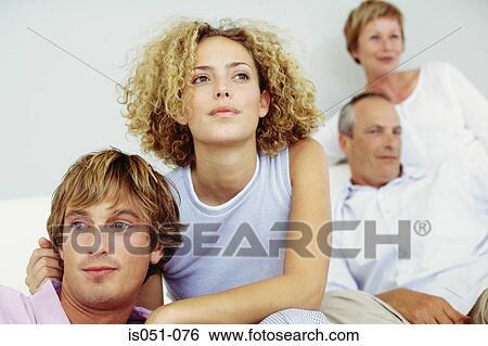 Young couple with in-laws in the background View Large Photo Image Stock Photograph - Young couple with in-laws in the background. Fotosearch