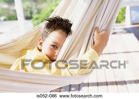 Stock Photograph - Boy relaxing in a hammock. Fotosearch
