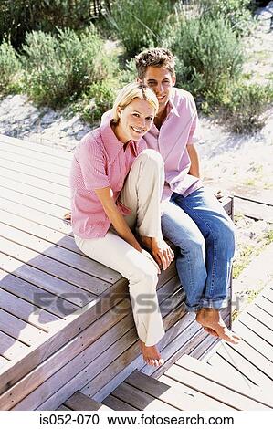Couple seated in the sun View Large Photo Image Stock Image - Couple seated in the sun. Fotosearch