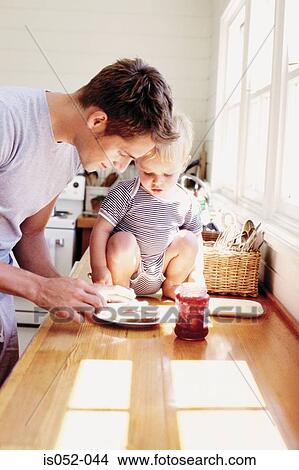 Father and child having breakfast View Large Photo Image Picture - Father and child having breakfast . Fotosearch
