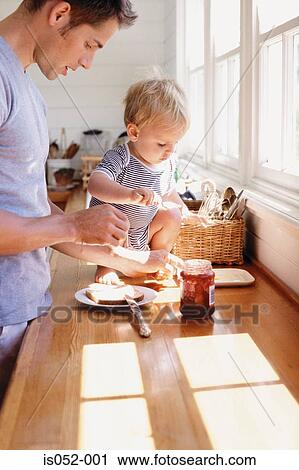 Father and child having breakfast View Large Photo Image Stock Image - Father and child having breakfast . Fotosearch