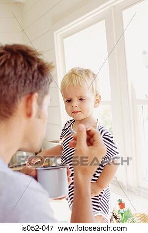 Father and child having breakfast View Large Photo Image Stock Photo - Father and child having breakfast. Fotosearch