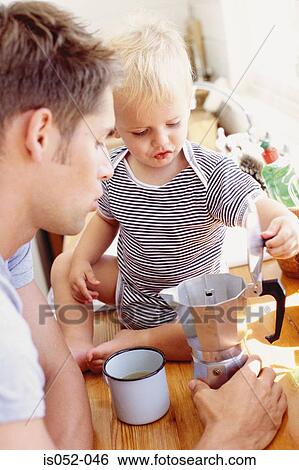 Father and child having breakfast View Large Photo Image Stock Photograph - Father and child having breakfast . Fotosearch