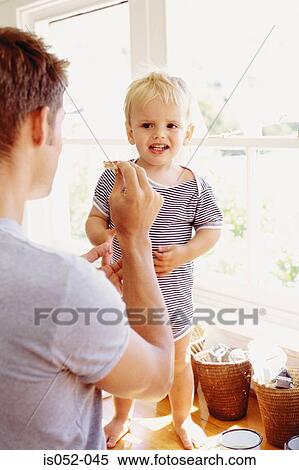 Father and child having breakfast View Large Photo Image Stock Photography - Father and child having breakfast. Fotosearch