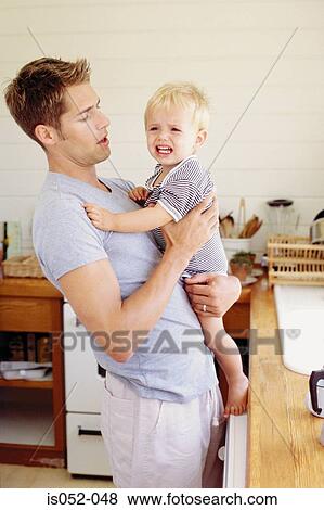 Father and crying child in the kitchen View Large Photo Image Stock Photo - Father and crying child in the kitchen. Fotosearch