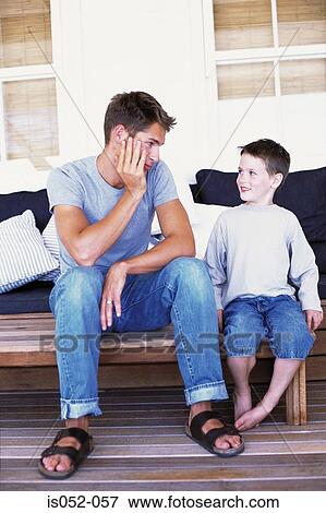 Father and son having a chat View Large Photo Image Stock Photo - Father and son having a chat. Fotosearch