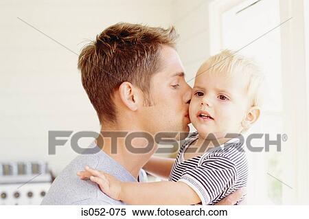Stock Photography - Father kissing son. Fotosearch