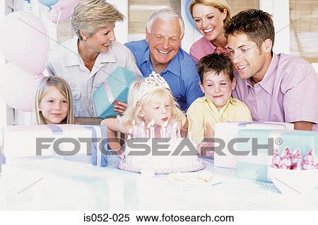 Stock Photography - Girl blowing out candles. Fotosearch