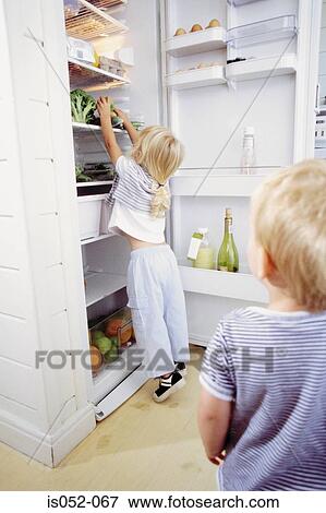 Girl in the kitchen View Large Photo Image Stock Photo - Girl in the kitchen . Fotosearch