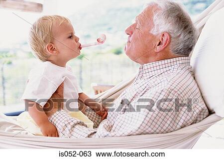 Grandad with grandson in a hammock View Large Photo Image Stock Image - Grandad with grandson in a hammock. Fotosearch