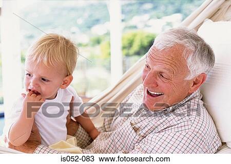 Stock Image - Grandad with grandson in a hammock. Fotosearch
