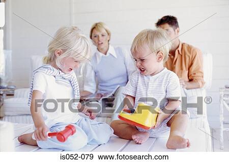Kids fighting over a toy View Large Photo Image Stock Photo - Kids fighting over a toy. Fotosearch