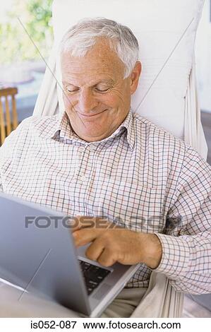 Man with a laptop in a hammock View Large Photo Image Stock Photo - Man with a laptop in a hammock. Fotosearch