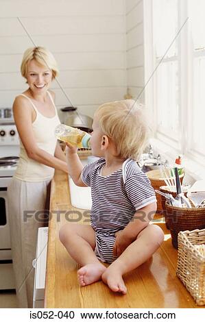Mother and child in the kitchen View Large Photo Image Stock Image - Mother and child in the kitchen. Fotosearch