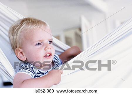 Stock Image - Portrait of a baby boy in a hammock. Fotosearch