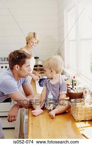 Picture - Young parents with child in the kitchen. Fotosearch