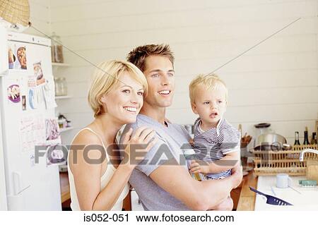 Young parents with child in the kitchen View Large Photo Image Stock Image - Young parents with child in the kitchen. Fotosearch
